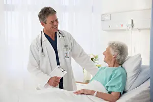 Expert Prints: Doctor talking to elderly patient in hospital