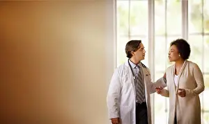 Doctors Prints: Doctor talking to a patient in a hospital room