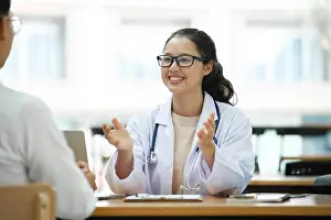 Examination Prints: Doctor talking to a patient at medical clinic