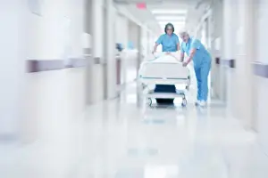 Corridor Prints: Two doctors pushing hospital bed