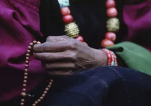 Nepal Prints: DOLPO WOMAN counts beads on her BUDDHIST ROSARY and wears a CORAL