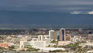 Staedtisch Prints: Downtown Tucson in Arizona with storm clouds Downtown area of Tucson in Arizona with the sun lighting the buildings