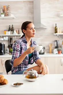 Dreamy girl enjoying hot green tea