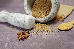 Dried Prints: Whole dried anise (Pimpinella anisum) seeds in a ceramic mortar and pestle
