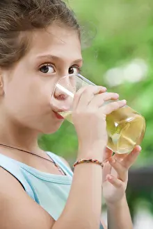 Thirsty Prints: drink portrait of nice little girl drinking juice in summer environment