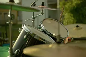Hardware Prints: Drum set gleaming in the golden hour light, ready for a performance