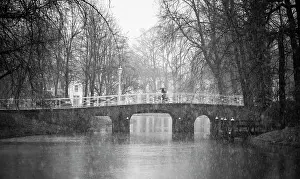 Bicycle Prints: A Dutch cyclist rides across a canal bridge in Utrecht, the Netherlands