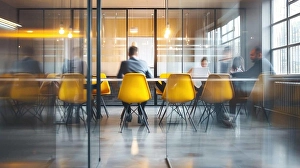 Sleek Prints: Dynamic Office Meeting in Modern Workspace with Vibrant Motion against Minimalist Background