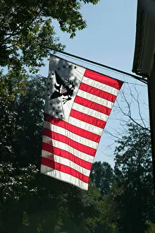 Virginia Prints: Early American flag is backlit in Yorktown