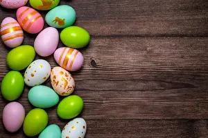 Ornate Prints: Easter eggs on wooden background. Colorful Easter eggs on a wooden background