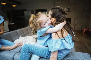 Schoen Prints: Elder and younger daughter on the big couch Elder and younger daughter posing together on the big couch at the camera