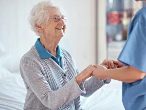 Elderly woman, nurse holding hands and nursing home support with medical professional exam