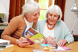 Converse Prints: Elderly woman reading information leaflet