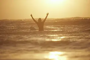 Arms Raised Prints: Embracing the golden hour at sea