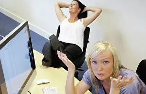 Thoughtful Prints: An Employee Is Frustrated While A Co_Worker Neglects Work