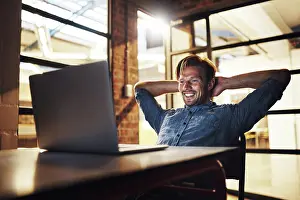 Deadline Prints: Employee, man and laid back on laptop at night with smile for email