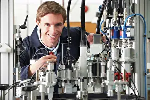 Fixing Prints: Engineer Working On Complex Equipment In Factory