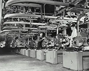Mechanical Prints: Engines are tested and assembled - held by mechanical arm in Ford motor Co