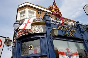 Capital Prints: England, London, Hackney. St George flags flying outside the British Lion pub on Hackney Road