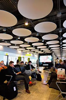 Disc Prints: England, London, Heathrow Airport Terminal 5 disc ceiling in departures zone with passengers waiting in seating area