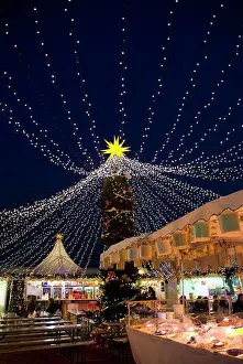Fair Prints: England, London, Hyde Park. Christmas lights over food and drink stalls at the Winter Wonderland in Hyde Park