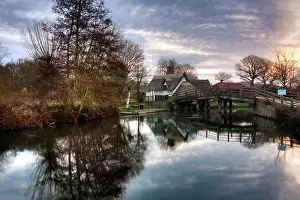 Dawn Prints: England, Suffolk, Flatford. A wooden bridge over the River Stour leading to the 16th century Bridge Cottage