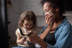 Prepare Prints: Ethnic woman showing daughter how to apply makeup