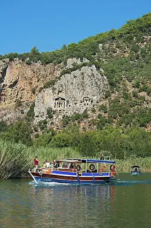 Trips Prints: Excursion boats on the Dalyan river in front of the rock tombs of Caunos or Kaunos near Marmaris