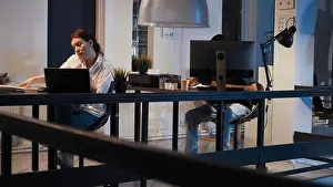 Call Prints: Executive manager working on laptop and answering landline phone call