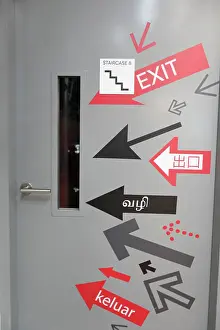 Language Prints: Exit signs door in a shopping center. Multi Language exit Sign. Singapore