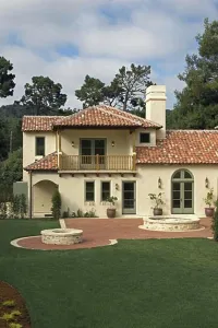 Verticals Prints: Exterior of a SPANISH STYLE LUXURY HOME with stucco walls and red tile roof