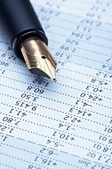 Financial Prints: extreme closeup of a fountain pen and charts