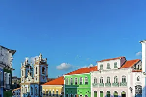 Balcony Prints: Facades of colorful houses and tower of an old baroque church in Pelourinho