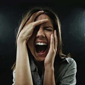 Depressed Prints: Face, stress and horror with woman screaming in studio on black background for reaction to fear