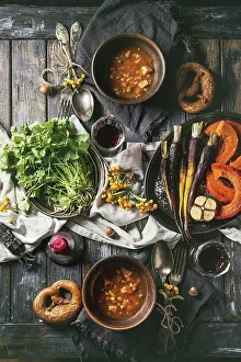 Back Ground Prints: Fall holiday table decoration setting with bowls of hot carrot potato soup