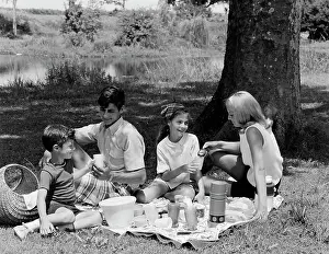 Serene People Prints: Family with two children having picnic in park