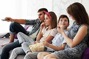 Thirty Prints: Family eating popcorn while watching television home