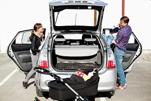 Entrances Prints: Family entering into car on street