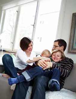 Father Prints: Family having fun in the couch