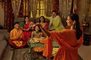 Occasion Prints: Family having fun together at home during Diwali celebration