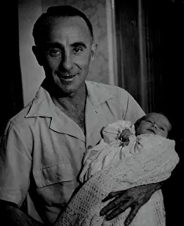 : Family Man. Jockey Billy Cook looked ***** he was caught by our cameraman today nursing his two weeks-old son