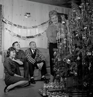 50 54 Years Prints: Family preparing Christmas tree in living room