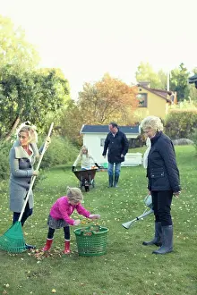 Grandma Prints: Family raking autumn leaves at yard