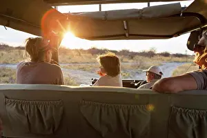 Small Group Of People Prints: family in safari vehicle, Kalahari Desert, Makgadikgadi Salt Pans, Botswana