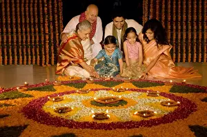 Expressions Prints: Family sitting near rangoli, Family