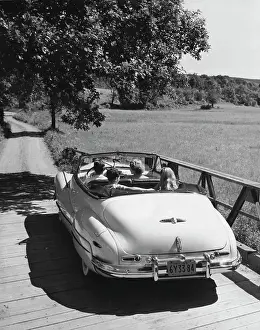 Medium Length Hair Prints: Family traveling in convertible car