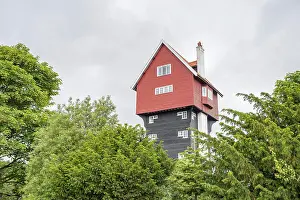 Residential Prints: The famous House in the Clouds pictured above a line of trees in Thorpeness in Suffolk