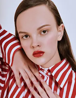 Attractive Prints: Fashion girl. Young brunette woman posing at studio in striped red and white shirt white skirt and trendy sandals