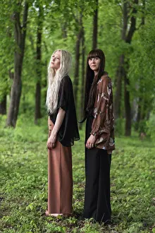 People In Nature Prints: fashion twin girls posing against the background of a forest lan