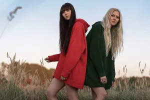 Kyiv City Prints: Fashion twin girls posing in bright clothes in the field